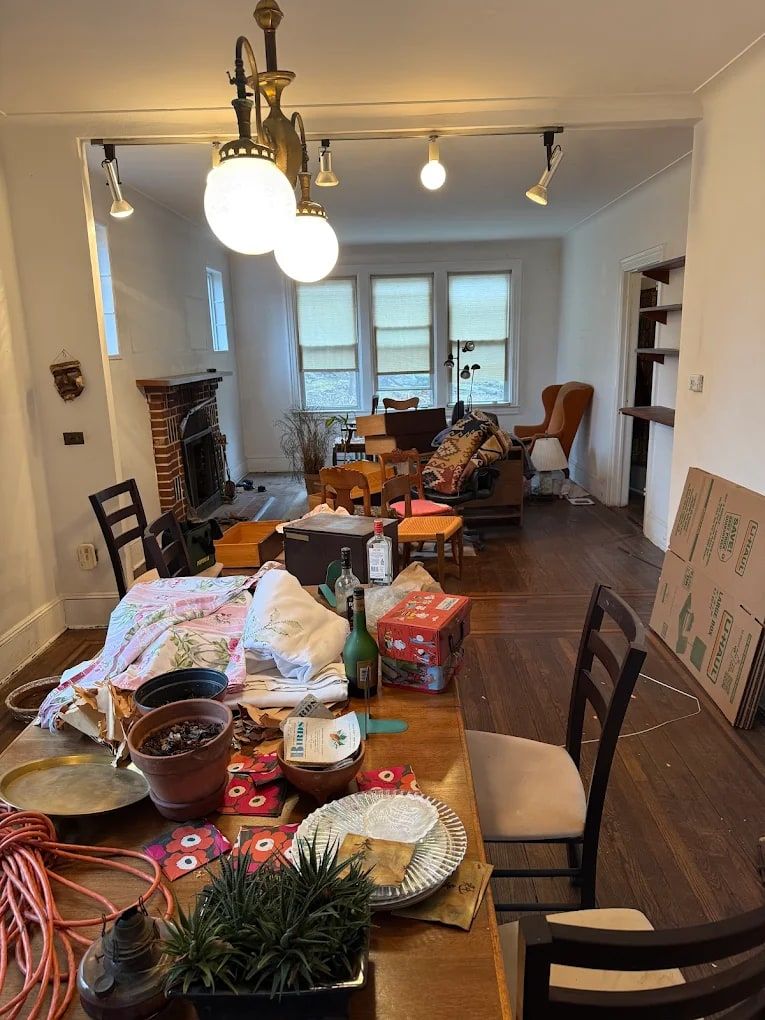 Dining room filled with dishes, boxes and belongings during an estate cleanout by Mitzvah Movers & Junk Removal