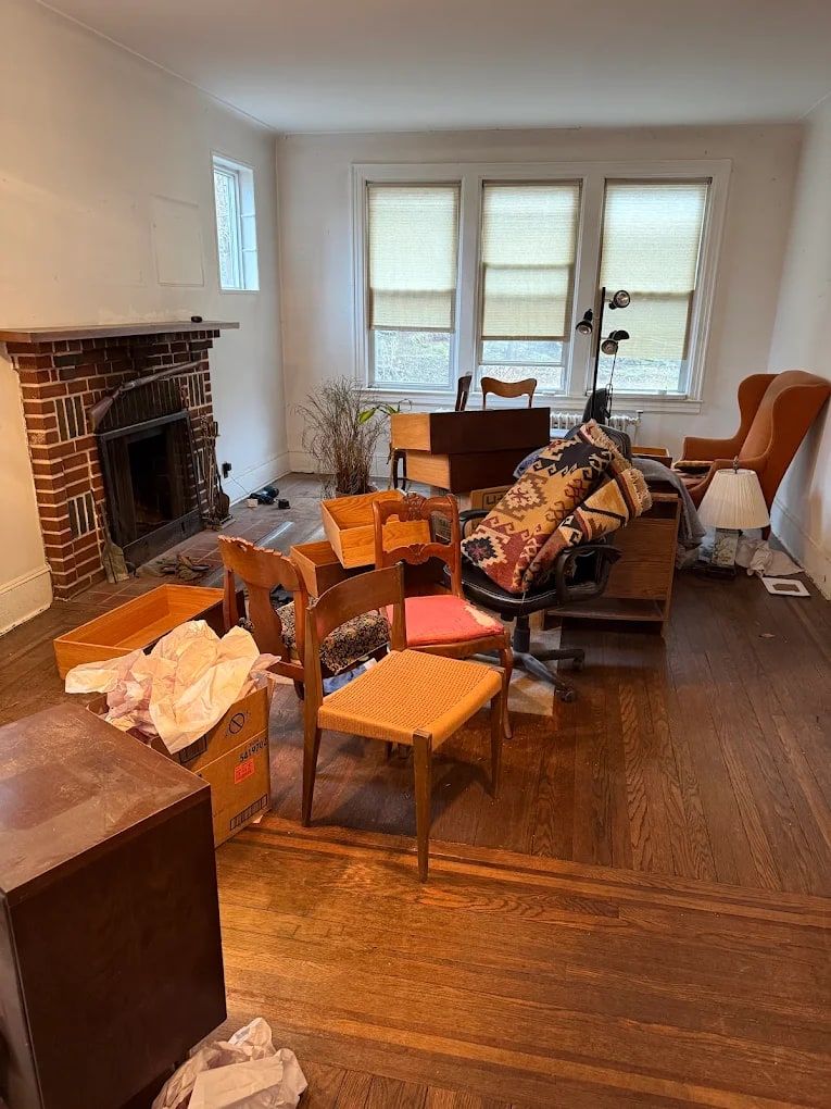 Living room full of old furniture and boxes at the start of an estate cleanout