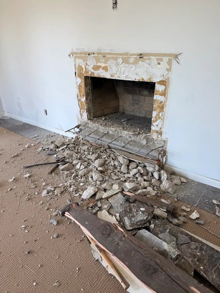 Broken brick and plaster on a carpet from a fireplace demolition, before debris removal