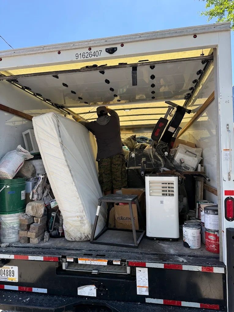 Mattress and household junk loaded into a box truck for mattress removal