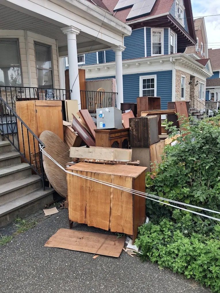 Old wooden dressers and cabinets carried out of a house for furniture removal